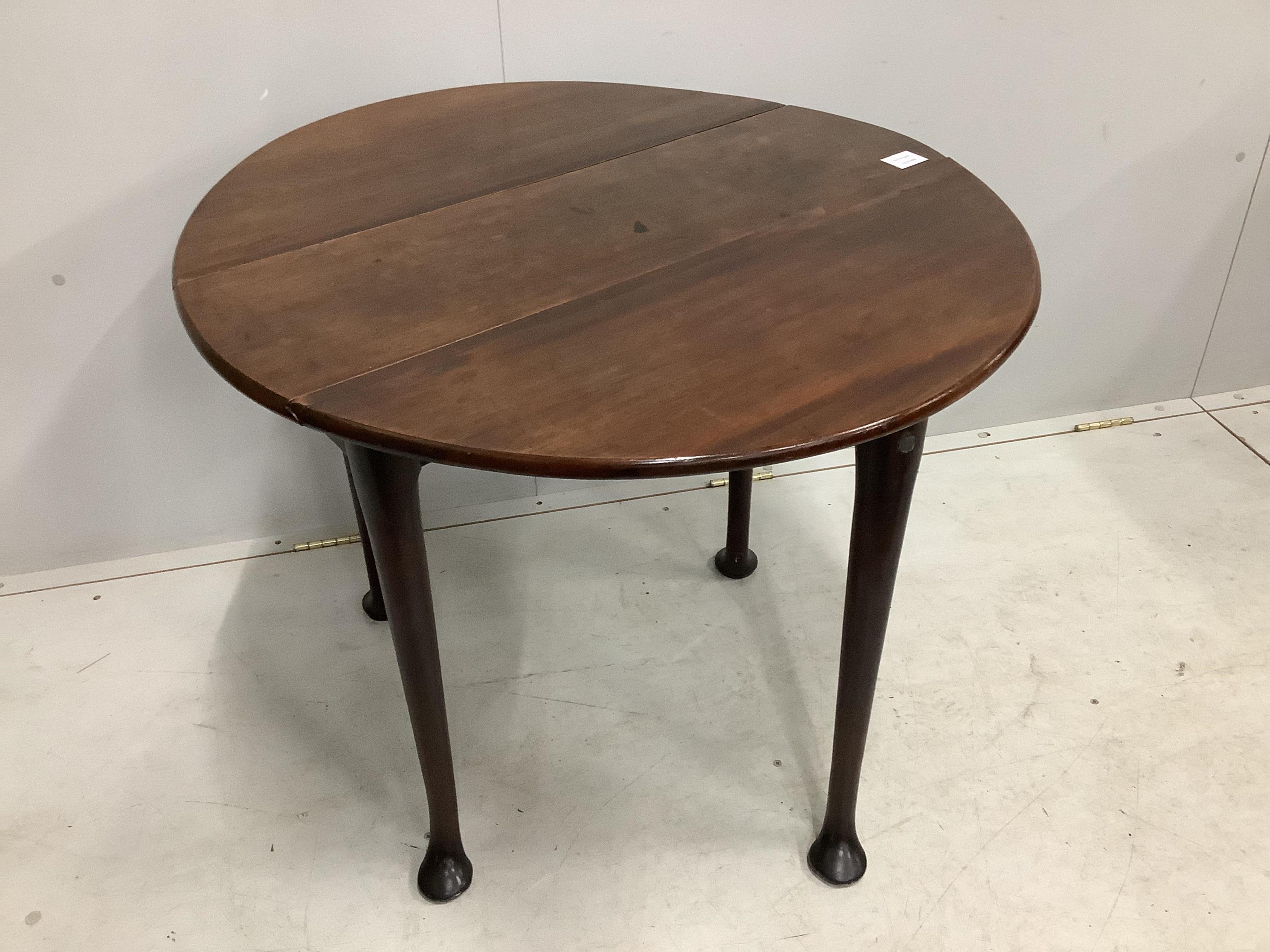 A small George III mahogany cottage drop leaf pad foot table, 85cm extended, depth 80cm, height 69cm. Condition - fair